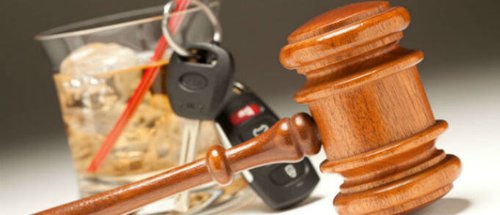 keys whiskey glass and gavel on table